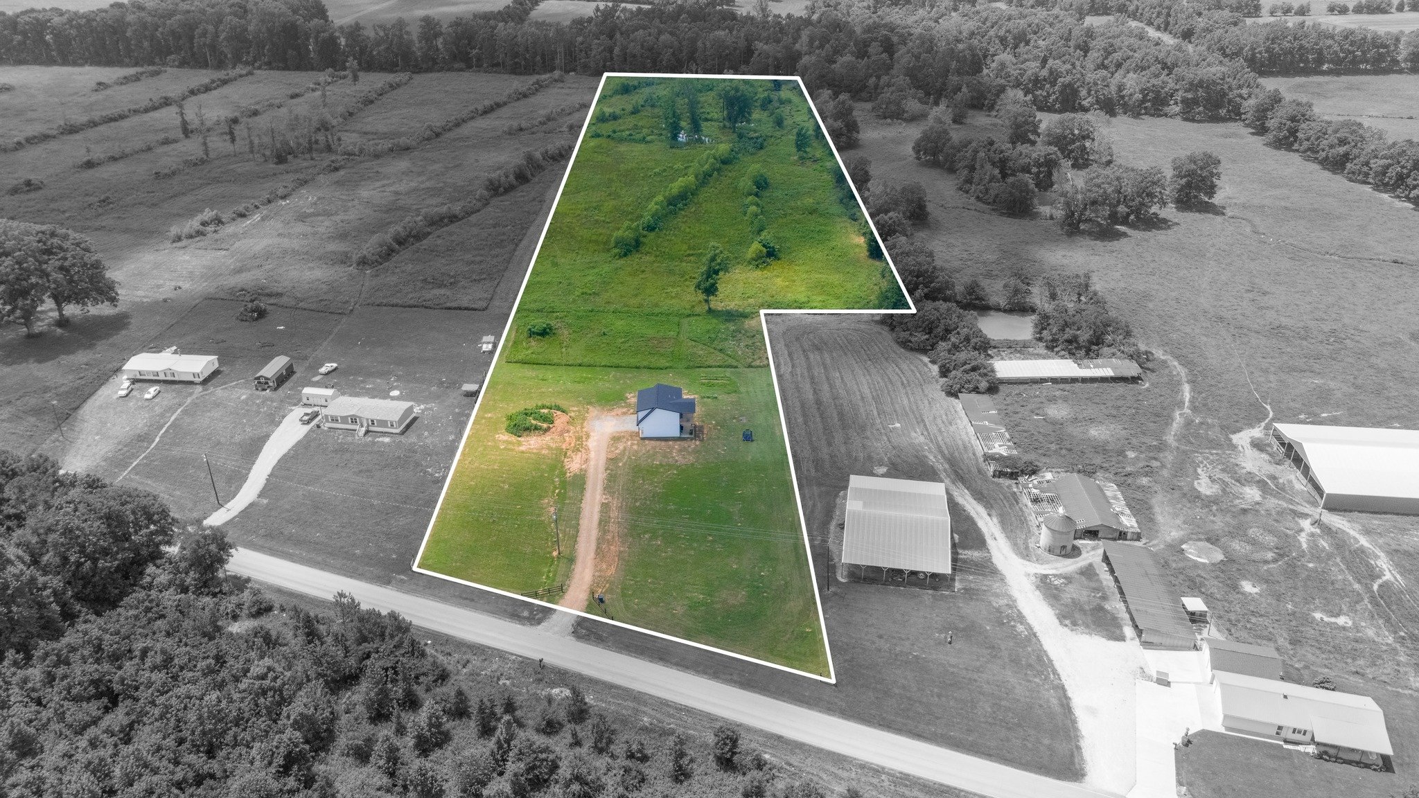 Aerial land photograph with a parcel outline and selective color highlighting